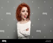 young cute redhead curly haired girl shows her tongue teasing on the gray backgroun in studio rg0bfe.jpg from ru tongue redhead little