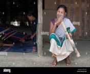 woman of chakma tribe smoking a bamboo pipe daba with man weaving on loom in background tripura india march 2012 w7n1k5.jpg from nm videos local d chakma bangali sex videogla magi video