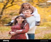 photo of mom dad and daughter walk through the autumn forest daughter sits on fathers shoulders w4n8j9.jpg from mom dad daughter