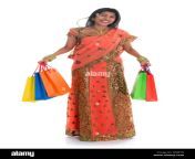 portrait of full length beautiful traditional indian woman in sari dress holding shopping bags isolated over white background wxje76.jpg from indian wife taking a whole fist in her chut