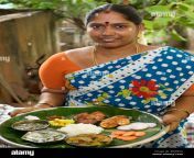 mrs vijayalakshmi neelakandan with a complete meal in a thali b5w63a.jpg from aunty thali