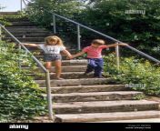 young brother and sister descend wooden steps in city park love care b8d96a.jpg from young step sis