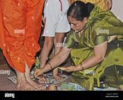 munjan ceremony mother of the child makes swastika on her husbands bmh4y2.jpg from aunty massaging with small xve