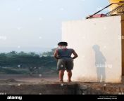 indian village boy with shadow having a pee in the morning outside bypeka.jpg from i village peeinge