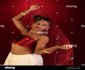 a model in fashionable strapless red blousewearing gold jewelery c1y6r2.jpg from aunty in red blouse wearing sari showing cleavage and hot navel