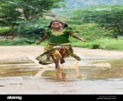 rural indian village girl running through a muddy puddle andhra pradesh de2ye3.jpg from nextpage desh village se