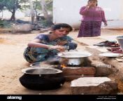indian woman cooking rice on an open fire outside her home in a rural dp8g2n.jpg from tamil village on housewife masala sex video downlo