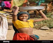 girl of adivasi tribe winnowing beans in village near poshina gujarat ed1ag2.jpg from desi adivasi video