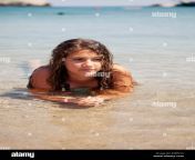 teenager girl laying in crystal clear water at kolymbia beach on rhodes edpn1c.jpg from teen nudist