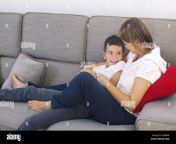 mother and son relaxing together on sofa exawn4.jpg from mom son share a couch mandy flores 720x405 jpg