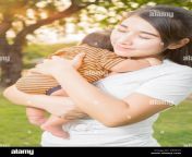asian 2 months baby feeling happy and smiles with her mother in the gf89yx.jpg from japan mom and sons firn the sex