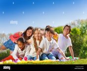 big group of happy 10 12 years old kids sitting on the lawn in the j4nrd7.jpg from 10 12yars old