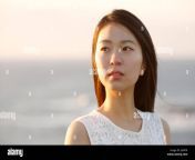 young japanese woman in a white dress at a cliff over the sea at sunrise jax87r.jpg from japani woman b