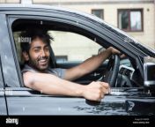 portrait of a happy indian man smiling in his new car k0ap5p.jpg from indian in car
