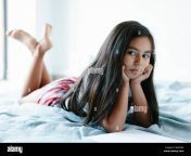 una nina de 9 anos esta acostada sobre una manta en la cama ella esta mirando a su derecha ella tiene largo cabello oscuro ella tiene caracteristicas de etnia hispana ella descansa su wb29ra.jpg from ella bergström
